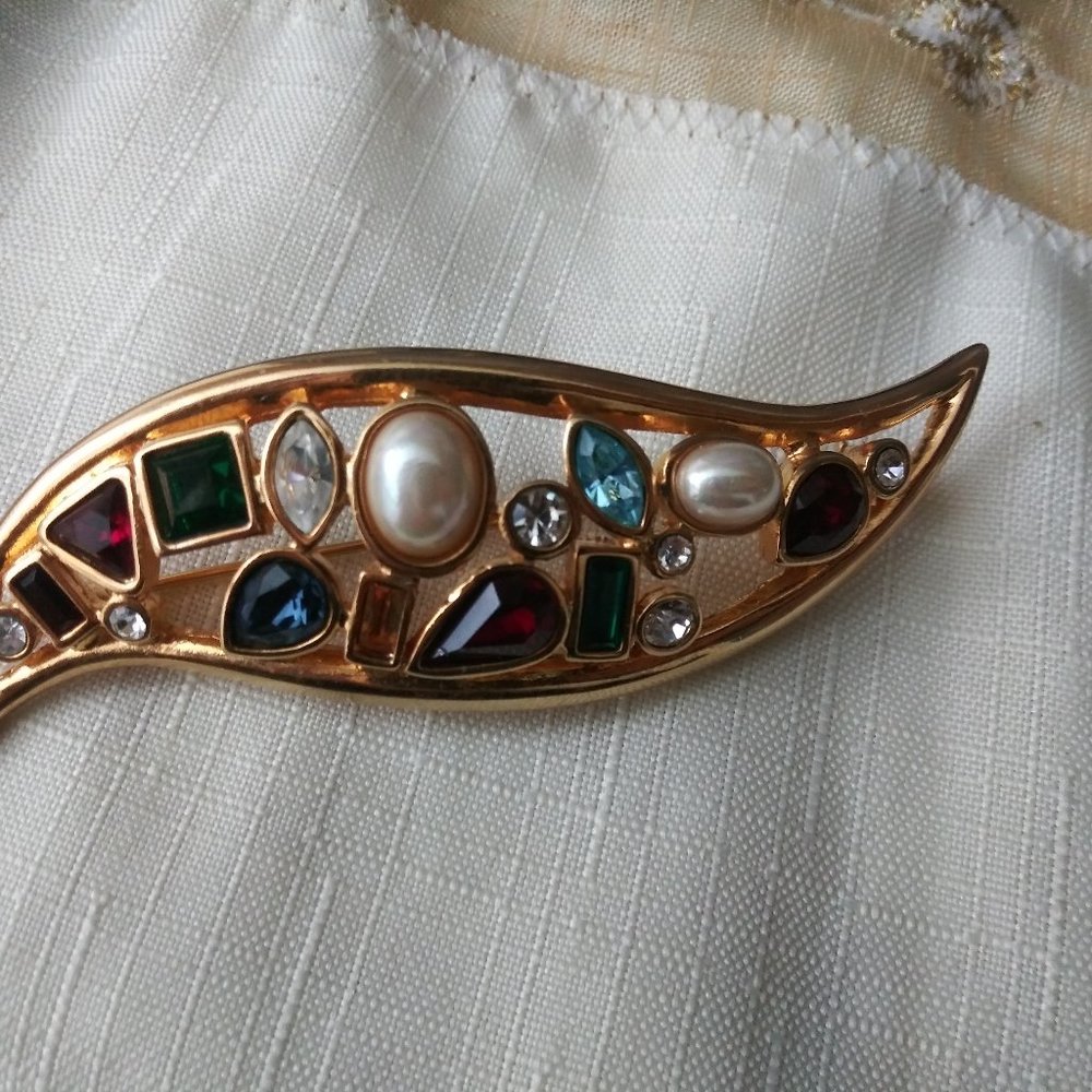Fancy gold colored broach with numerous gems